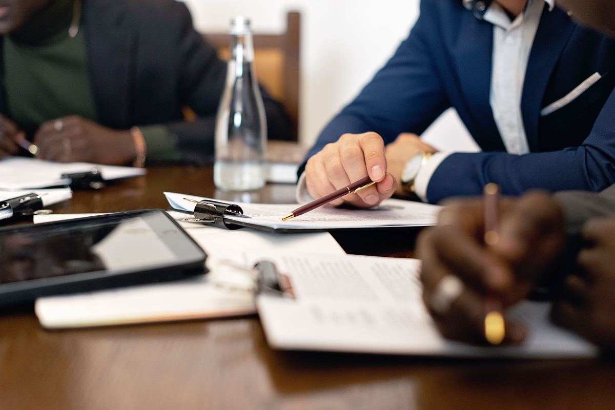 Business colleagues reviewing documents around a meeting table