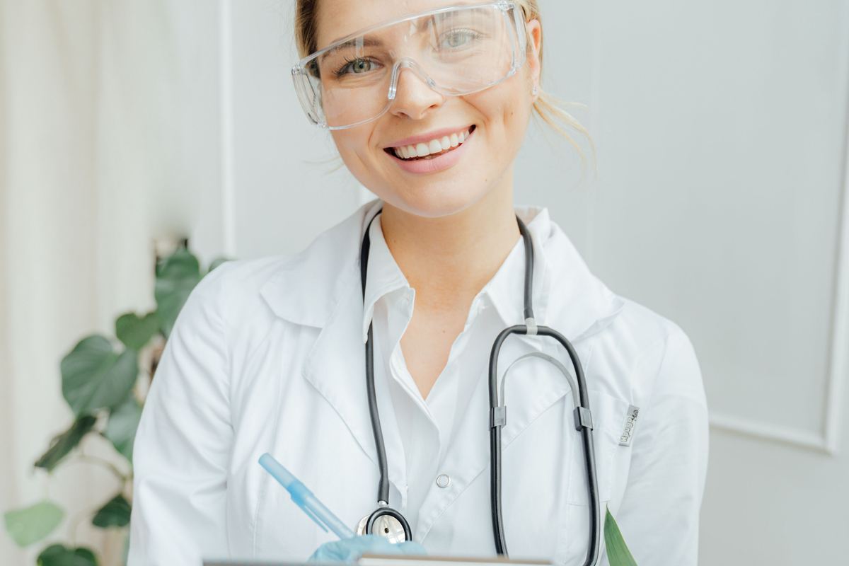 Travel nurse in a white coat holding a clipboard