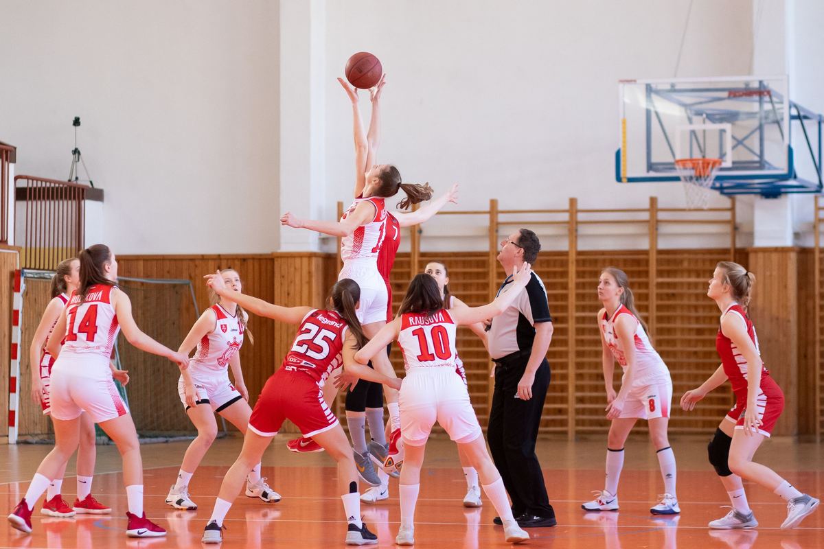 Girls basketball teams competing during an indoor tournament game